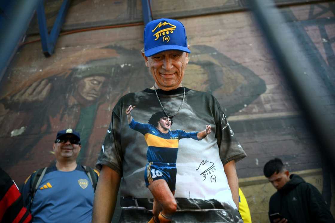A fan wearing a Diego Maradona hat and shirt in Boca Juniors colours at the club's La Bombonera stadium in Buenos Aires on October 9, 2025 A fan wearing a Diego Maradona hat and shirt in Boca Juniors colours at the club's La Bombonera stadium in Buenos Aires on October 9, 2025