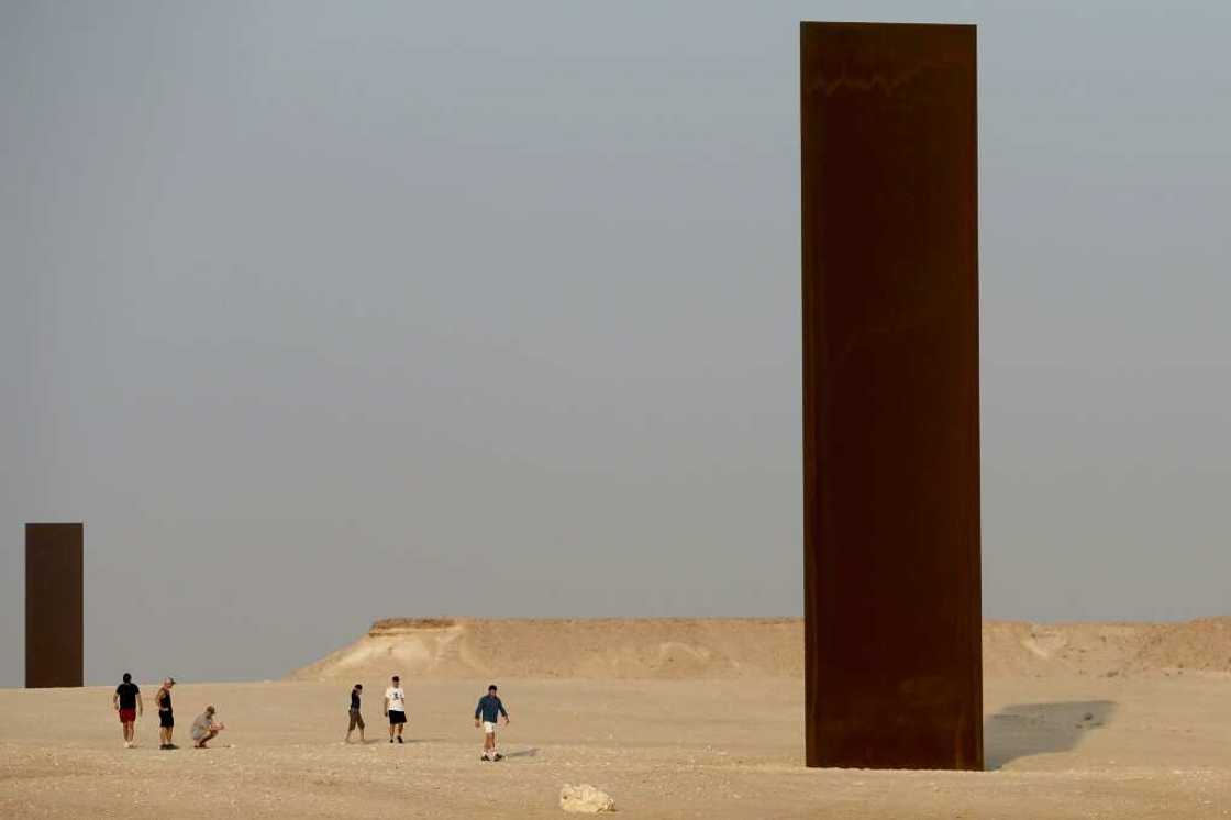 Two of the four steel slabs of US artist Richard Serra's "East-West/West-East" installation in the Qatari desert Two of the four steel slabs of US artist Richard Serra's "East-West/West-East" installation in the Qatari desert