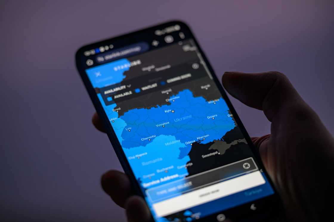 A phone screen displaying a map showing the Starlink coverage A phone screen displaying a map showing the Starlink coverage