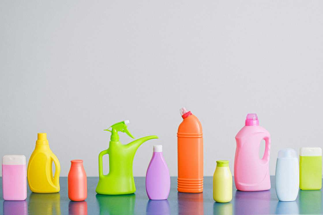 Assorted cleaning supplies on a blue surface