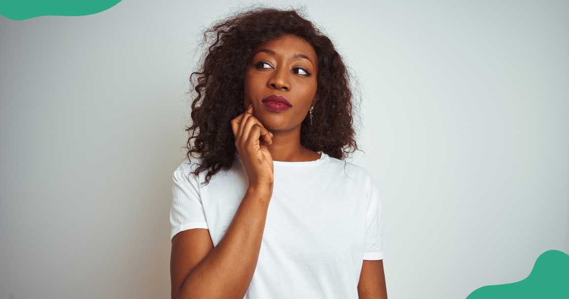 A woman is pictured against a grey background