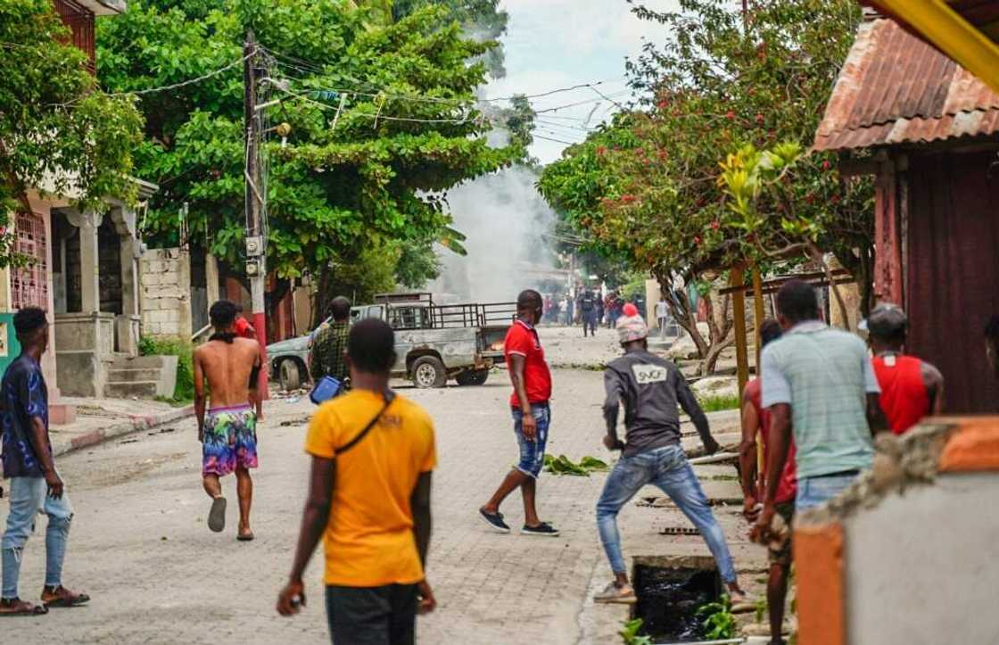 Haitians throw stones at the police during a violent demonstration in August 2022; they were protesting the rising cost of living and insecurity as the country, the poorest in the Western hemisphere, is mired in gang violence and political turmoil