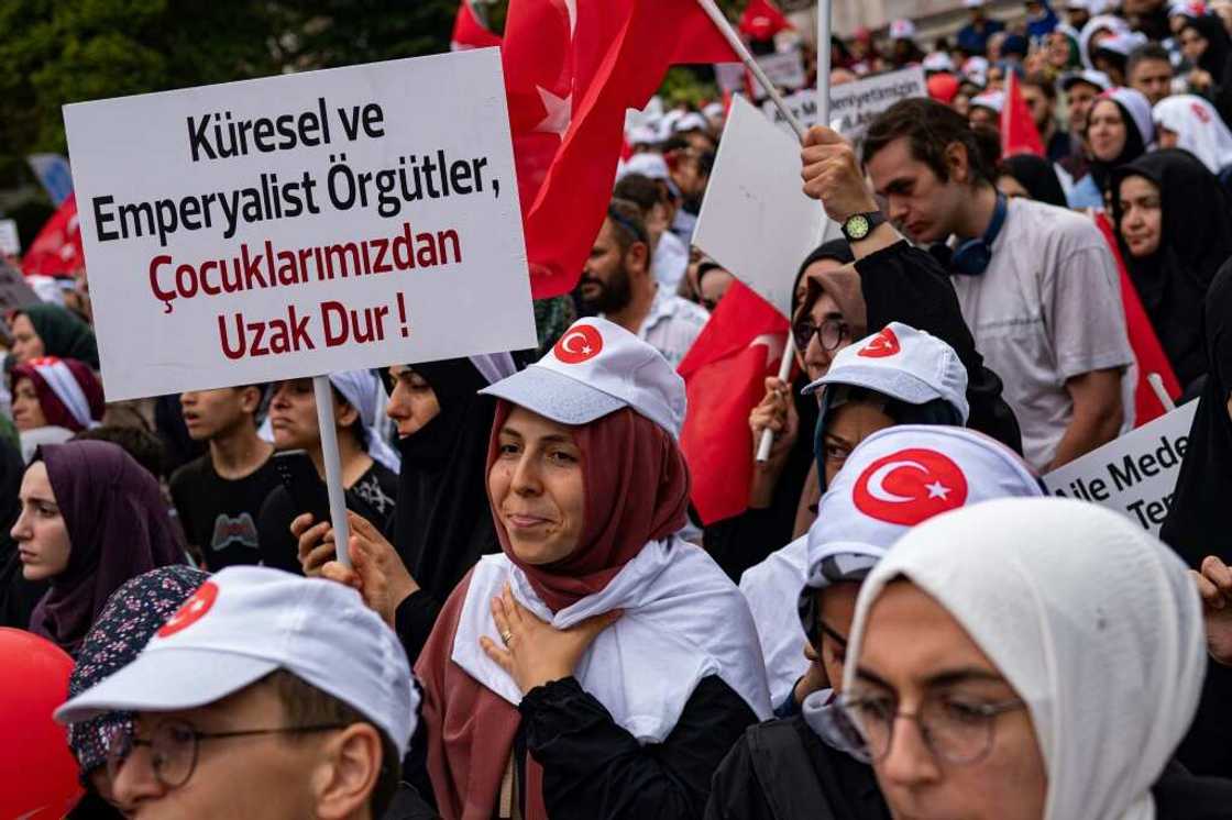 A protester holds a placard during an anti-LGBT rally organised by pro-Islamic organizations in Istanbul on September 18, 2022