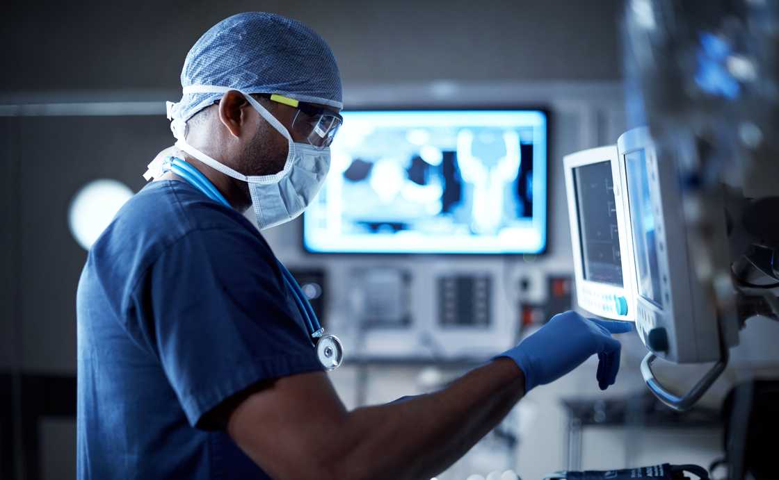 A surgeon looking at a monitor in an operating room.