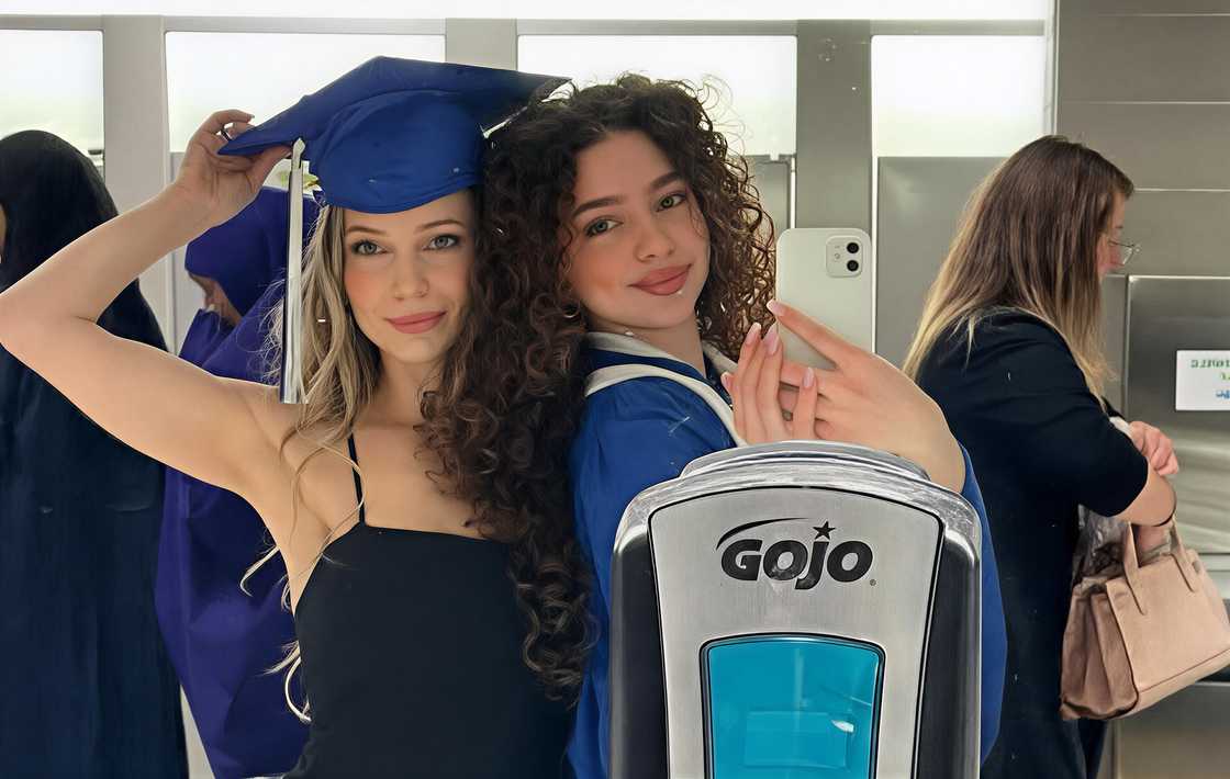 Patrisha Kalogeras and her Demitra pose during a graduation ceremony