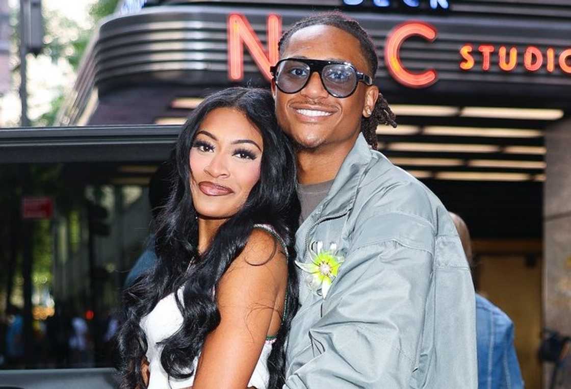 Taylor Williams holds Clarke Carraway outdoors Taylor Williams holds Clarke Carraway outdoors