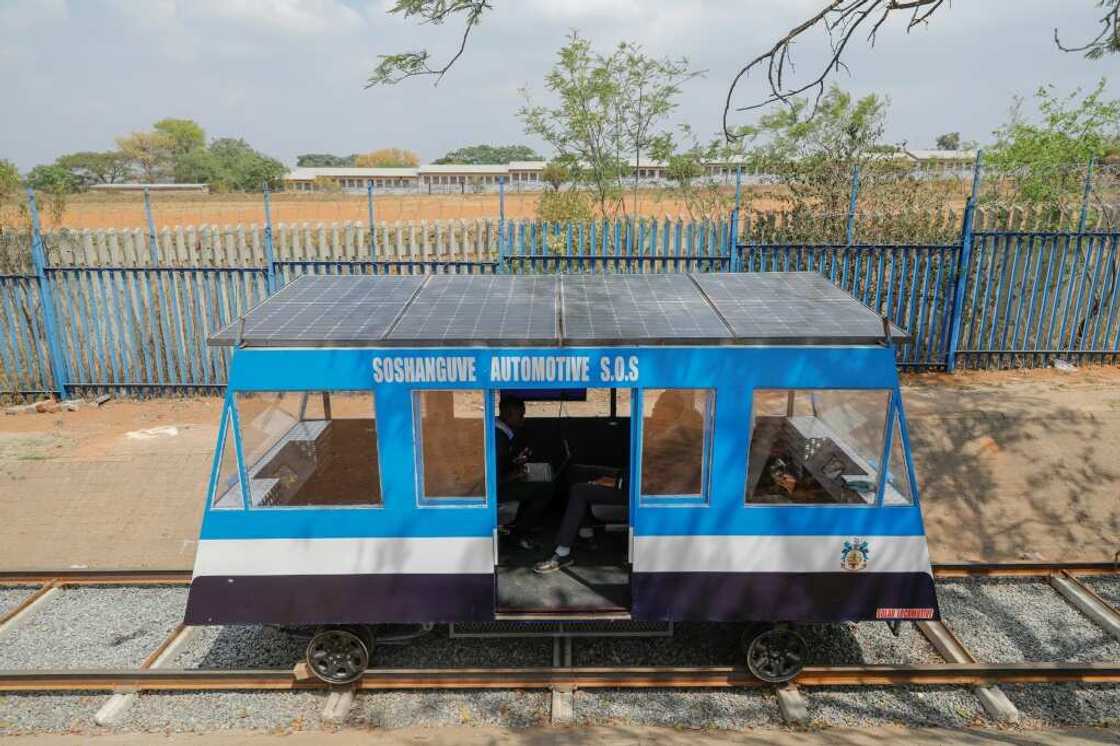 Photovoltaic panels fitted on rooftop, the blue-and-white train moves on an 18-metre long testing track in Soshanguve township