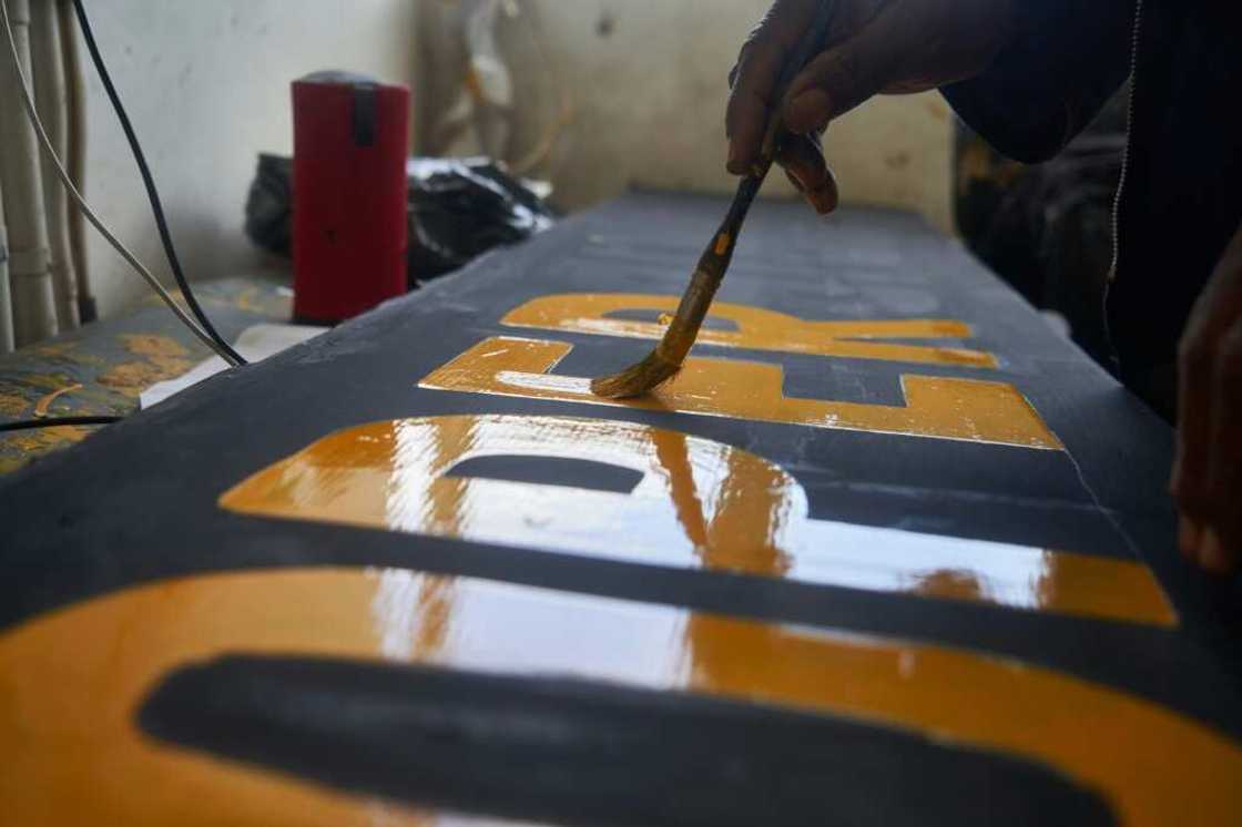 Victor Ndlovu works on Netherlands' batsman Tom Cooper's name tag ahead of their T20 World Cup qualifier agaisnt Zimbabwe Victor Ndlovu works on Netherlands' batsman Tom Cooper's name tag ahead of their T20 World Cup qualifier agaisnt Zimbabwe