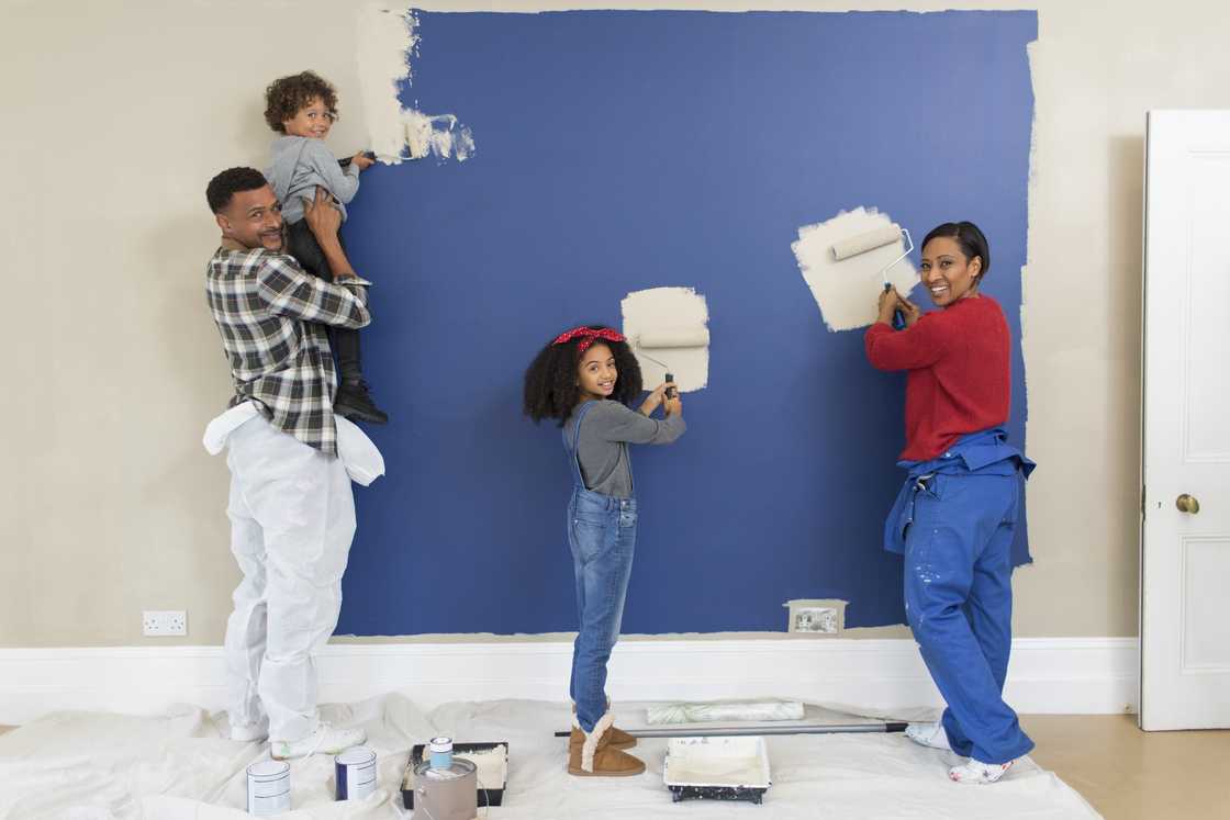 A family painting a bedroom together. A family painting a bedroom together.