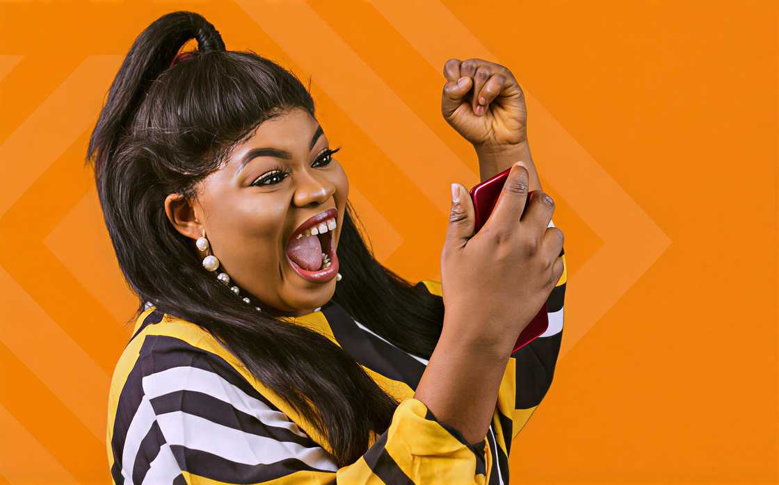 A lady smiling looking at her mobile phone