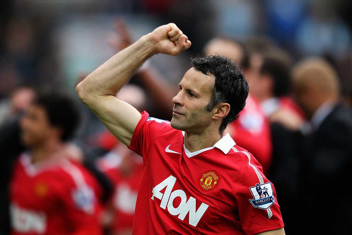 Ryan Giggs pumps his fist to the fans during a match