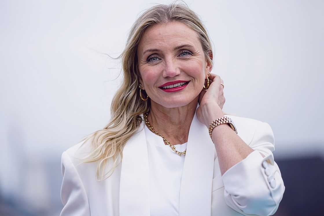 Cameron Diaz touches her hair during a photocall