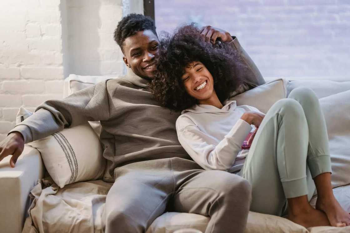 A young happy couple sitting on a couch