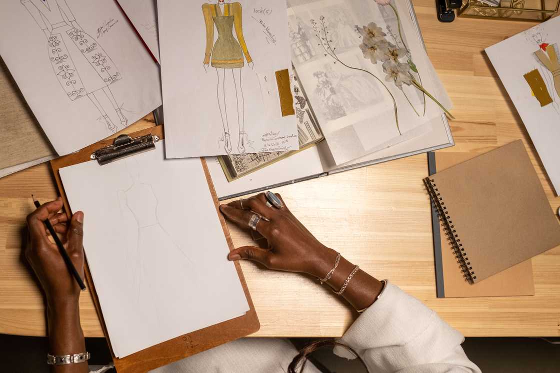 A fashion designer sketching on paper