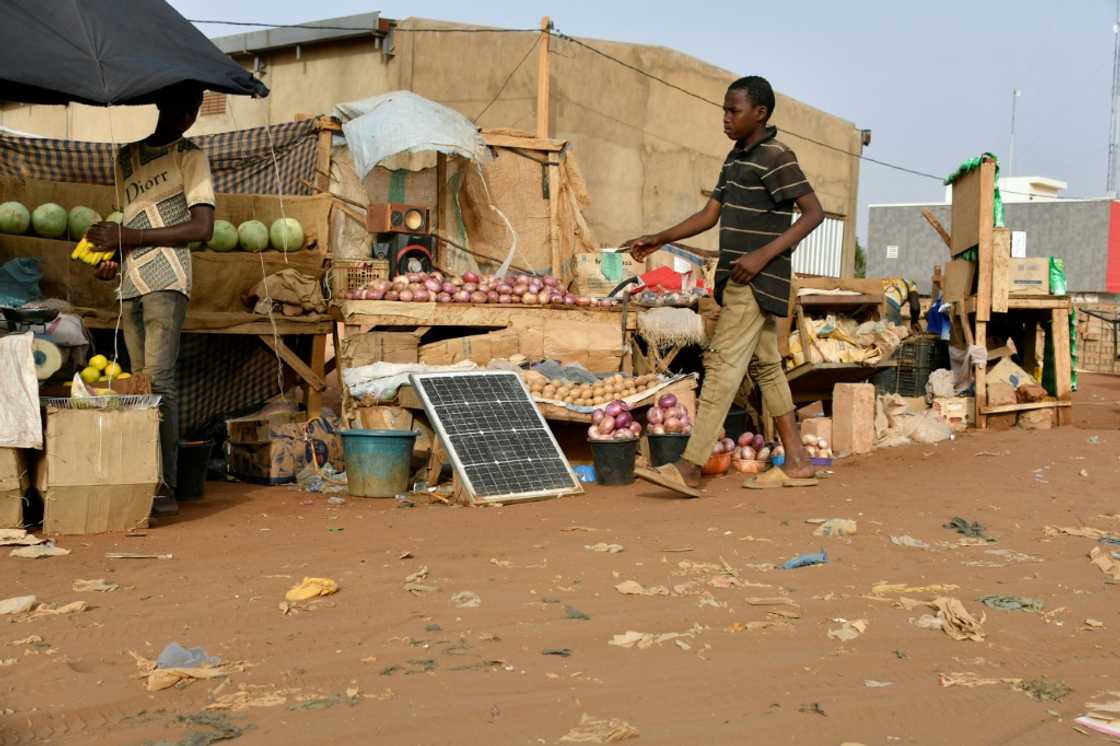A fruit vendor earns extra money by letting people charge their phones from his solar panel A fruit vendor earns extra money by letting people charge their phones from his solar panel