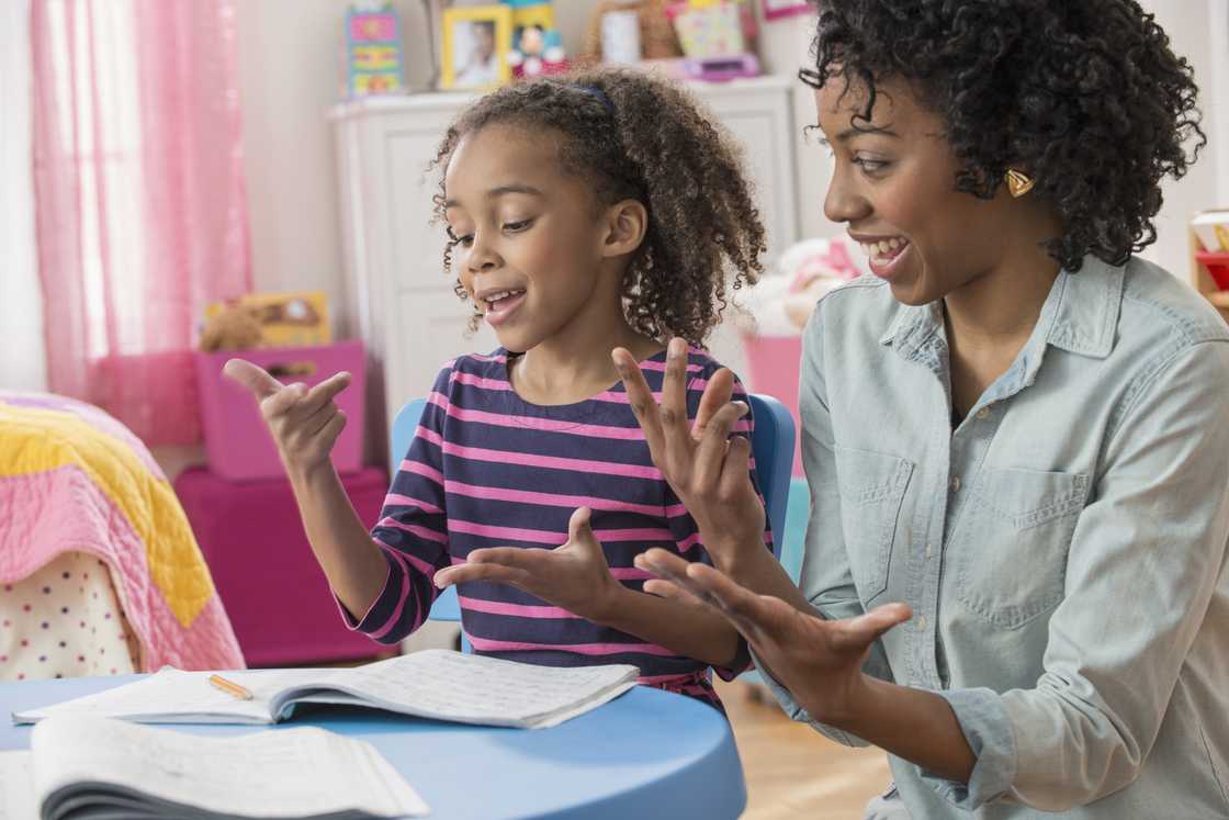 A mother helping her daughter study. A mother helping her daughter study.