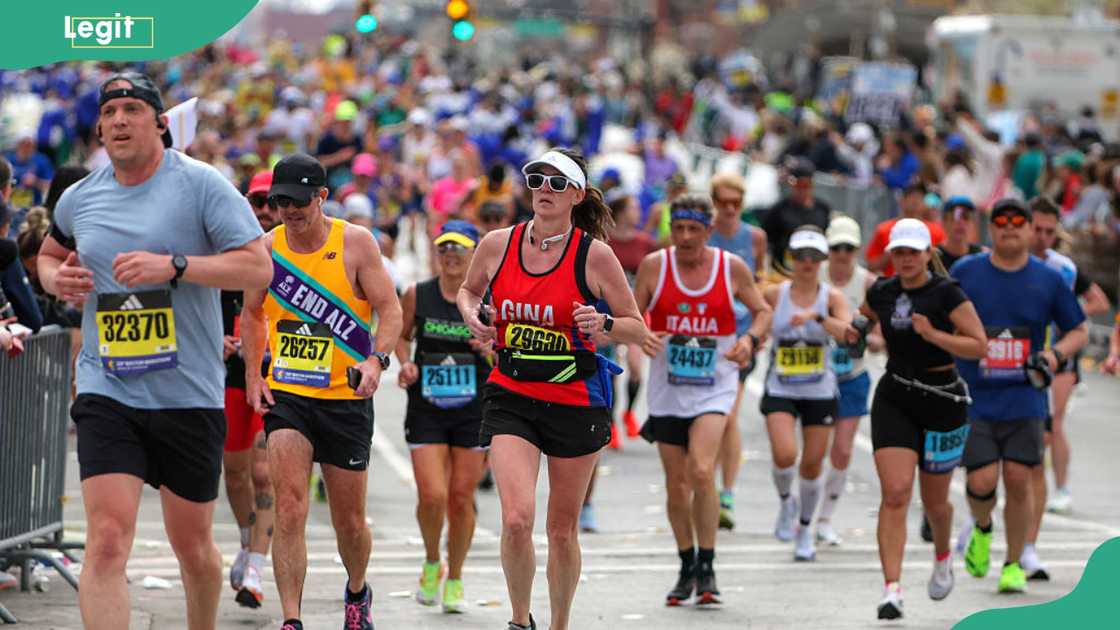 Runners reach the final mile marker Runners reach the final mile marker