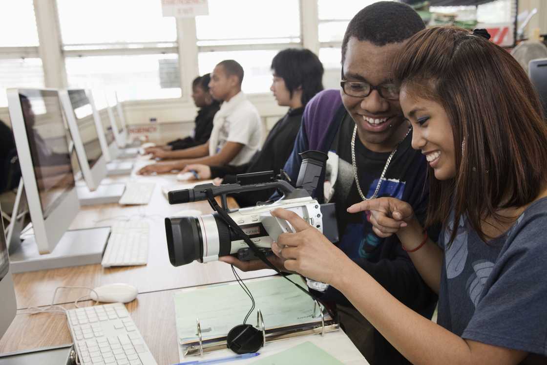 Students with a video camera in the computer lab