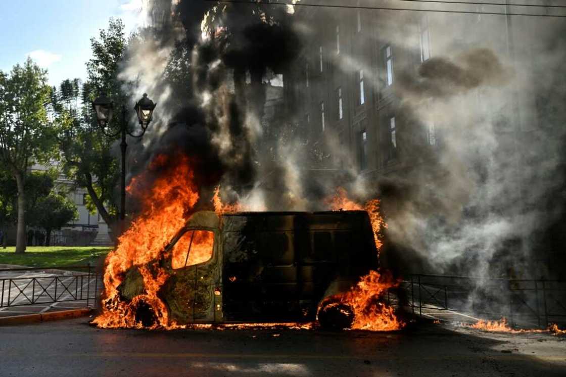 A van was torched during protests in Athens over the country's deadliest rail crash A van was torched during protests in Athens over the country's deadliest rail crash