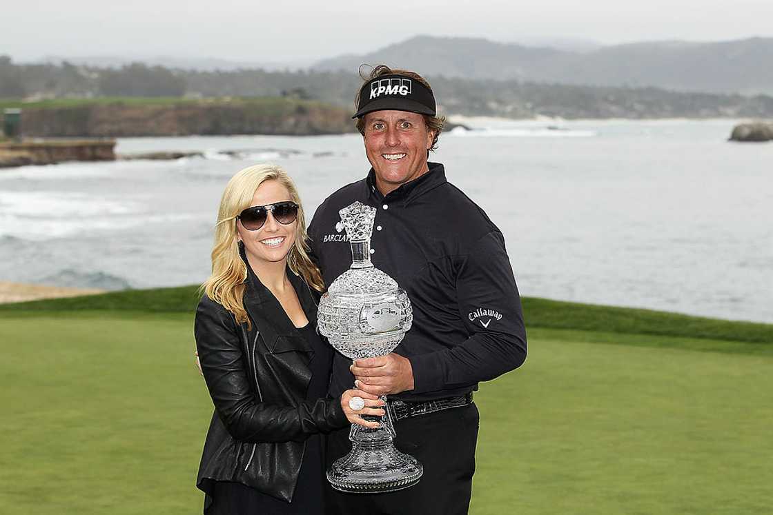 Phil and Amy Mickelson hold a trophy after his victory Phil and Amy Mickelson hold a trophy after his victory