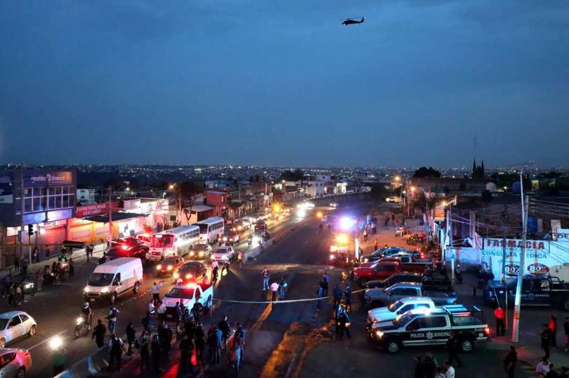 Police inspect an area where suspected gang members set a bus on fire in the western state of Jalisco Police inspect an area where suspected gang members set a bus on fire in the western state of Jalisco