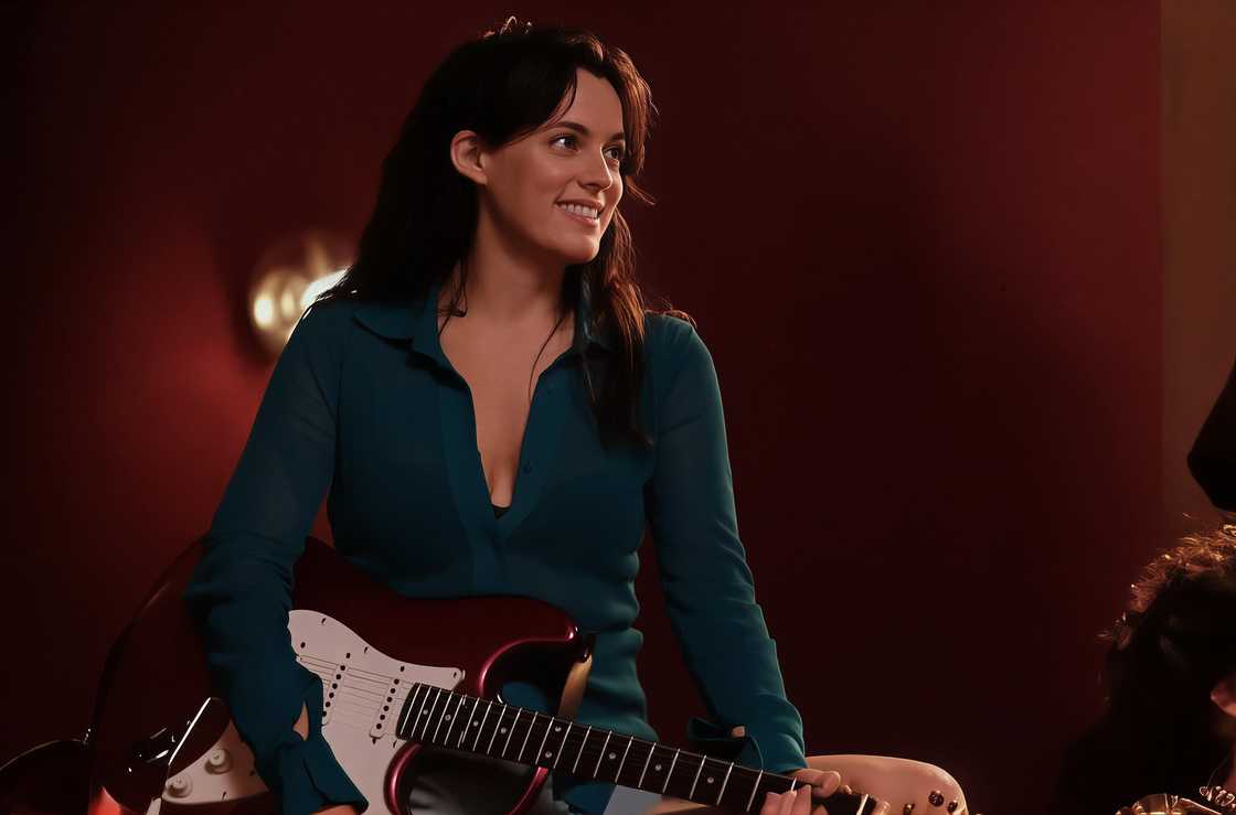 Riley Keough holds a guitar in a scene from Rosebush Pruning Riley Keough holds a guitar in a scene from Rosebush Pruning