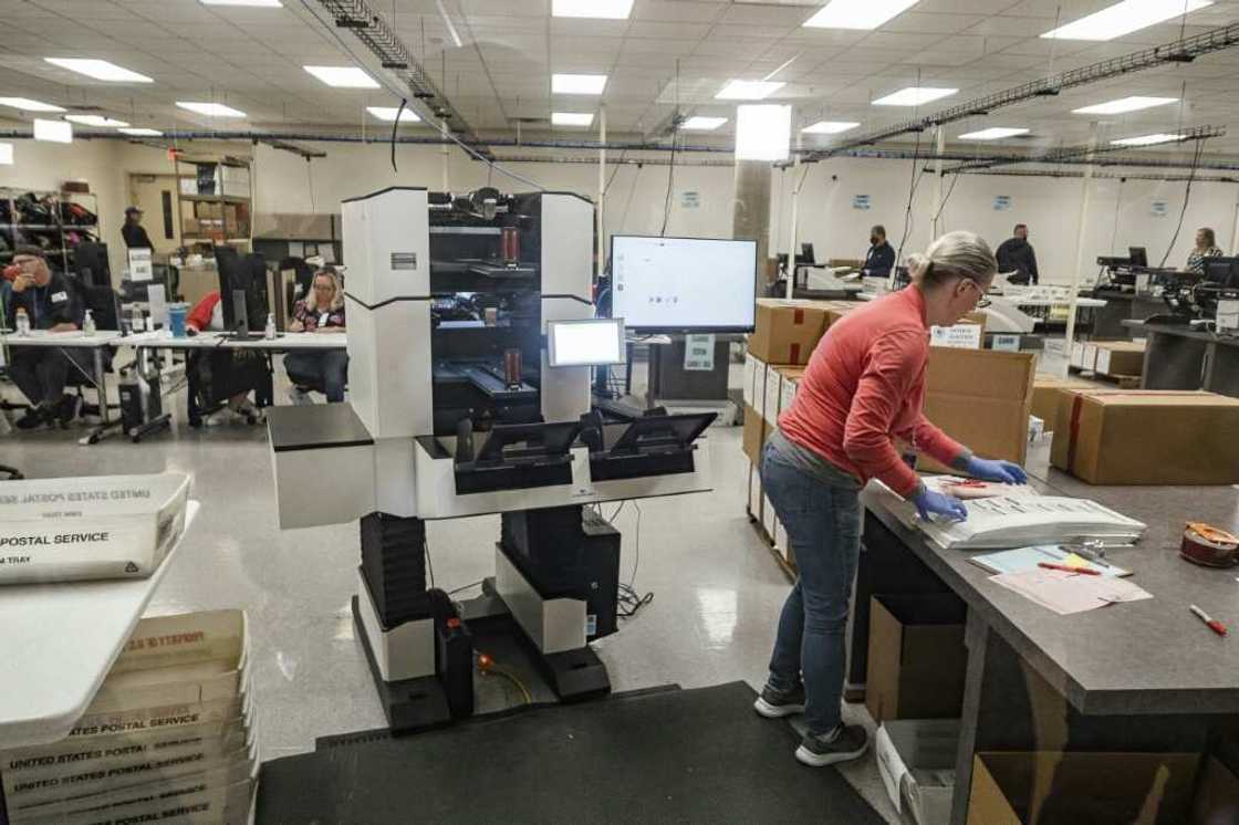 Election workers handle ballots from the US midterm election in Phoenix, Arizona Election workers handle ballots from the US midterm election in Phoenix, Arizona