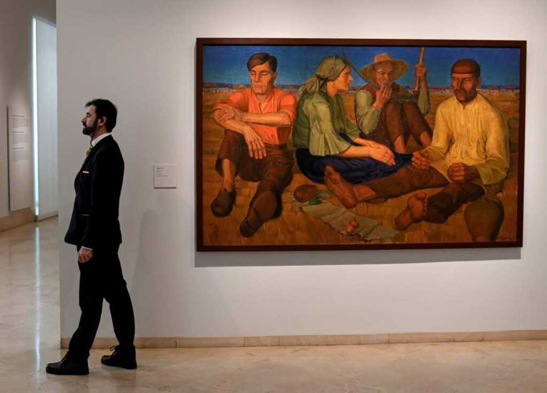 A gallery assistant stands near 'Rest' by Oleksandr Syrotenko at the 'In the Eye of the Storm' exhibition A gallery assistant stands near 'Rest' by Oleksandr Syrotenko at the 'In the Eye of the Storm' exhibition