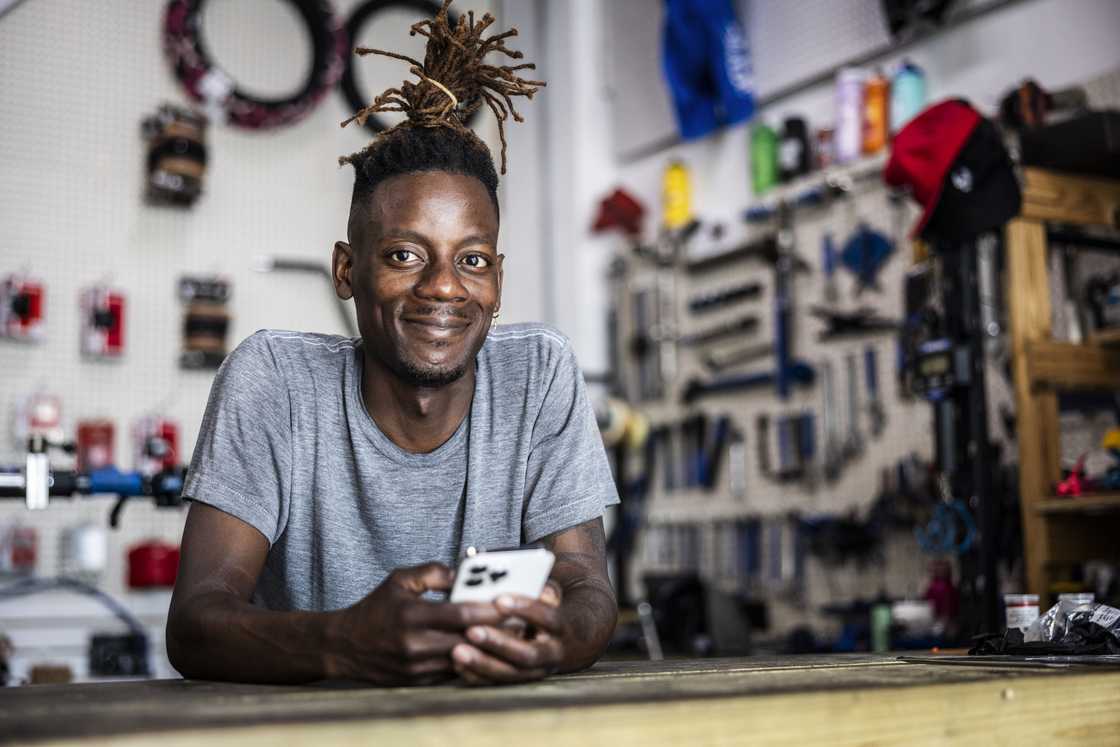 A professional phone repair man in a kiosk A professional phone repair man in a kiosk