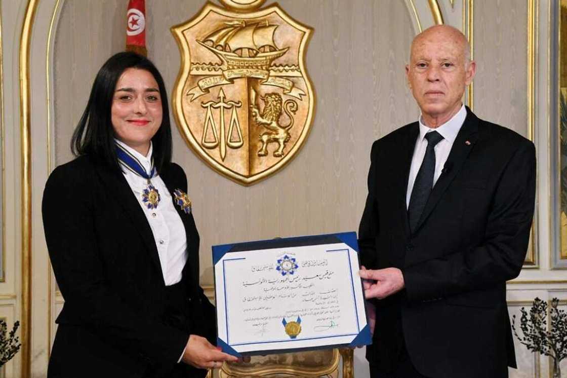 Star treatment: A handout picture shows Tunisian President Kais Saied presenting Ons Jabeur with the Order of Sports Merit award Star treatment: A handout picture shows Tunisian President Kais Saied presenting Ons Jabeur with the Order of Sports Merit award