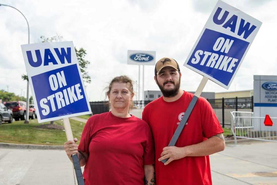 Ramona Jocys and her son-in-law Adam Gallup pose outside a Ford assembly plant on the first day of the United Auto Workers strike in Detroit, Michigan