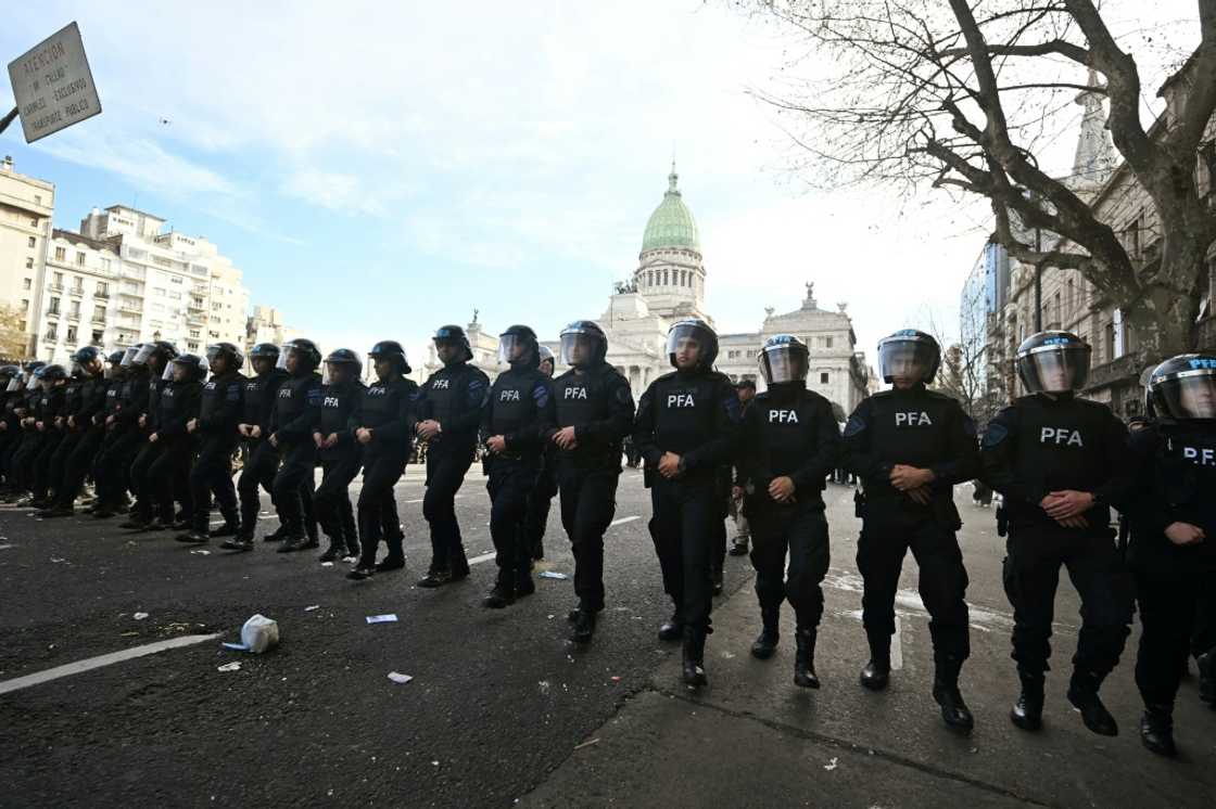 Riot police stand guard during a protest outside the National Congress in Buenos Aires on September 11, 2024