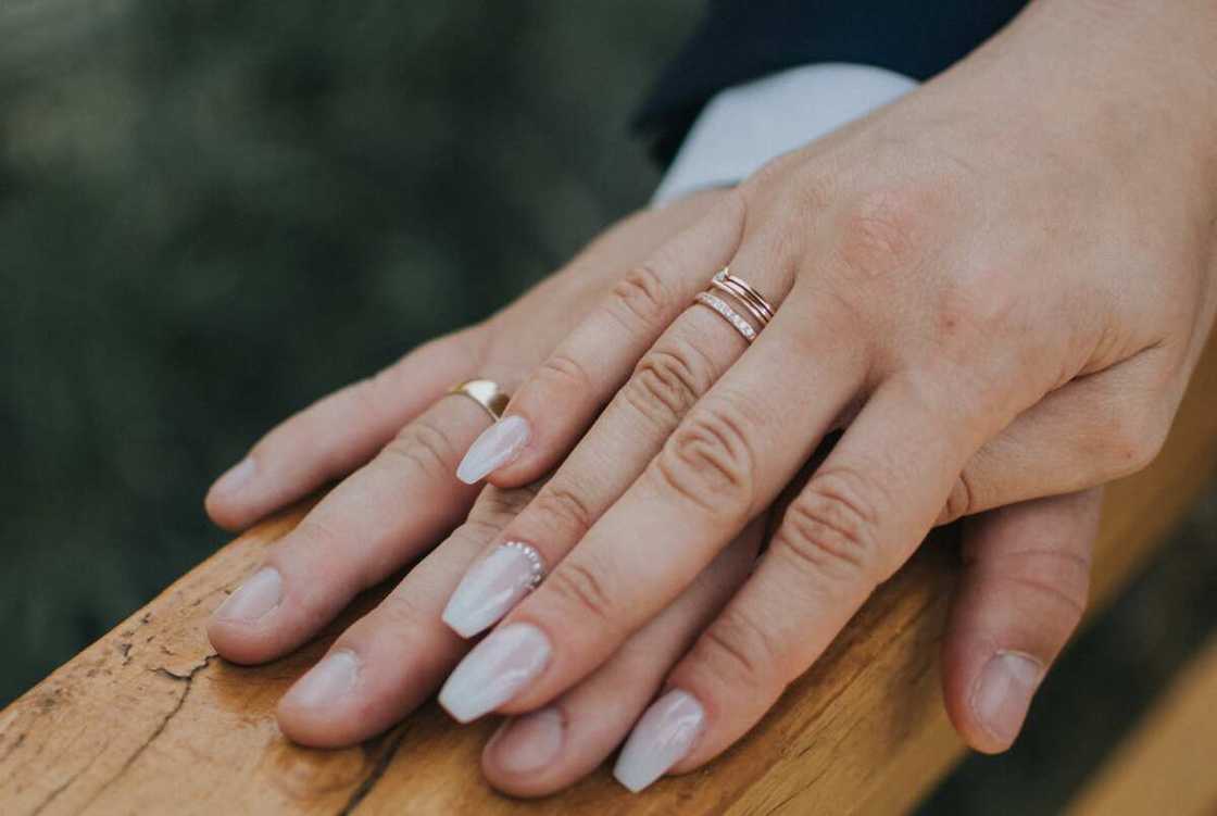 A married couple's hands in wedding rings A married couple's hands in wedding rings