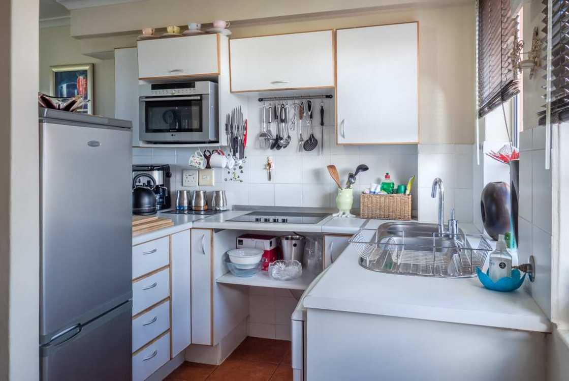 A small and well-equipped white-themed kitchen A small and well-equipped white-themed kitchen