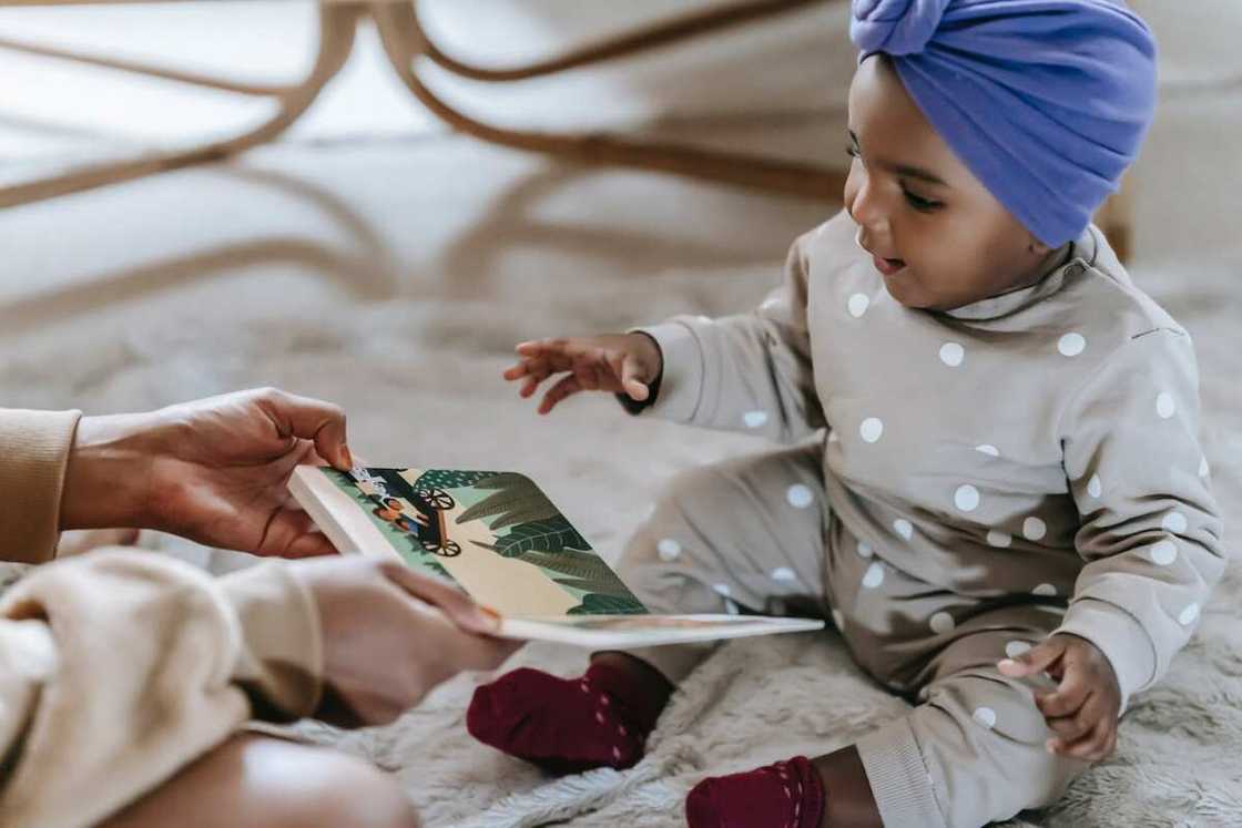 A child looking at story book smiling