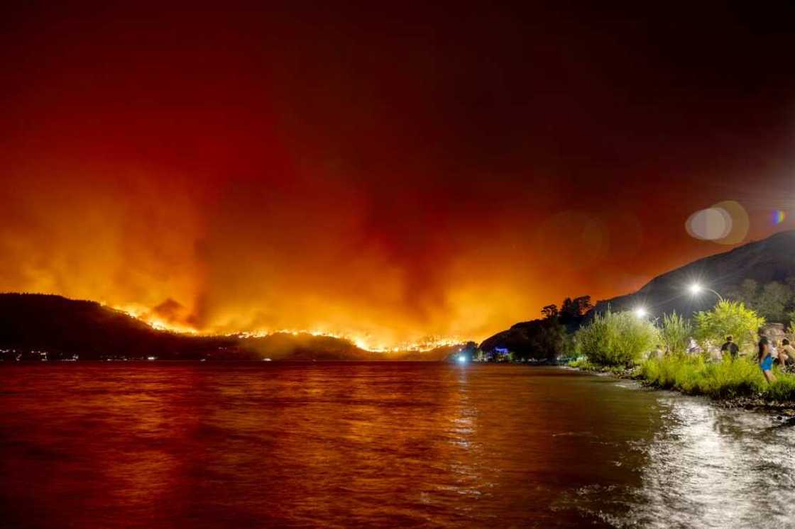 Residents watched from the water's edge the McDougall Creek wildfire in West Kelowna in western Canada in August 2023 Residents watched from the water's edge the McDougall Creek wildfire in West Kelowna in western Canada in August 2023