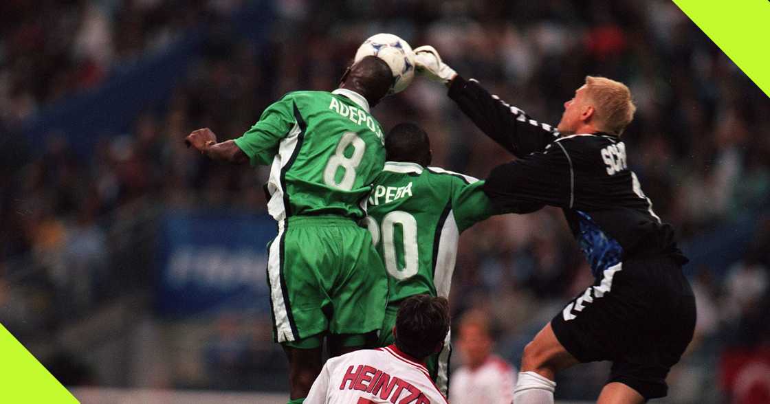 Mutiu Adepoju competes for the ball with Peter Schmeichel