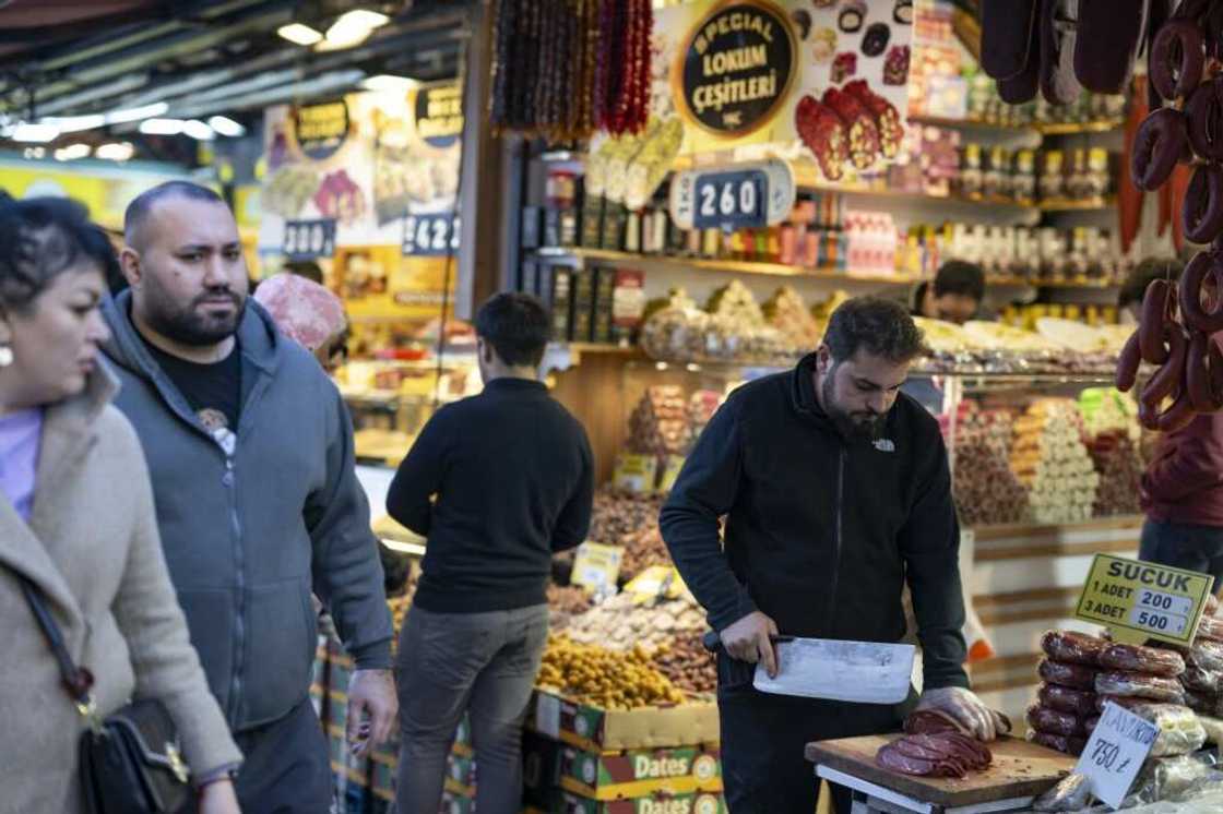 Turkey's central bank holds its key interest rate steady at 50 percent