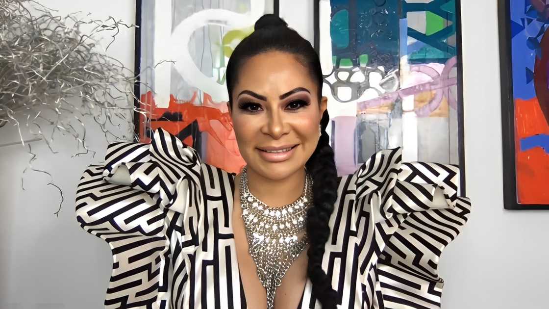 Jen Shah in a striped gown and a silver necklace smiling Jen Shah in a striped gown and a silver necklace smiling
