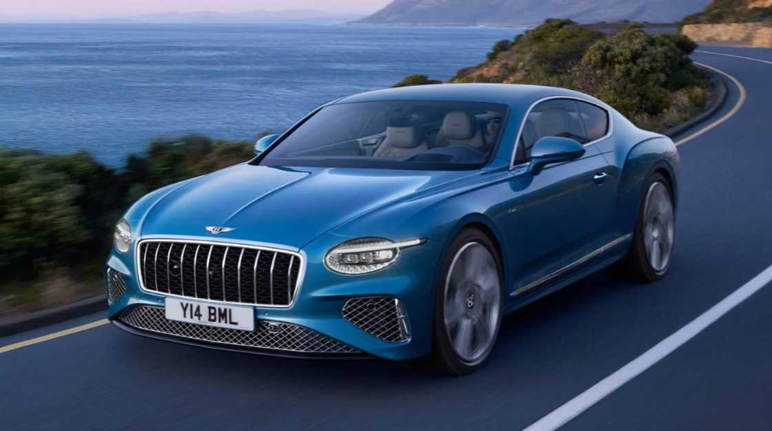 A blue Bentley Continental GT driving through a peninsula A blue Bentley Continental GT driving through a peninsula