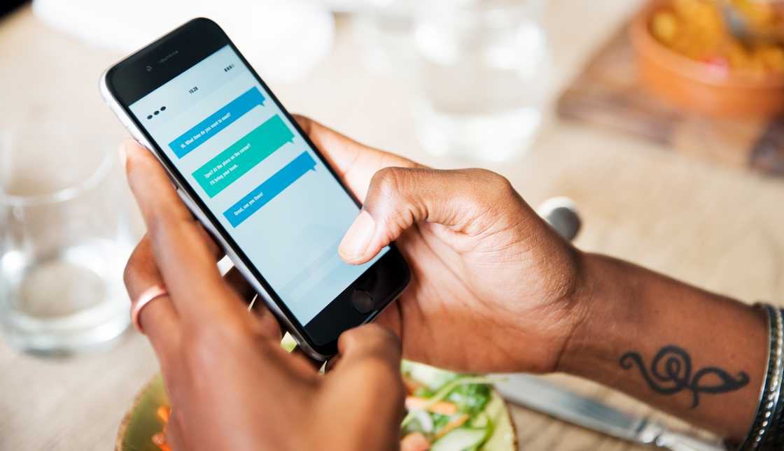 A person holds and uses their smartphone.