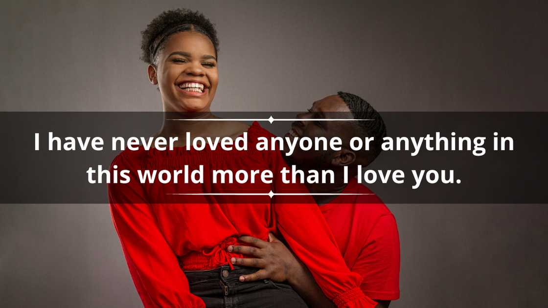 A happy couple in matching red tops and black denim pants is posing for a picture A happy couple in matching red tops and black denim pants is posing for a picture