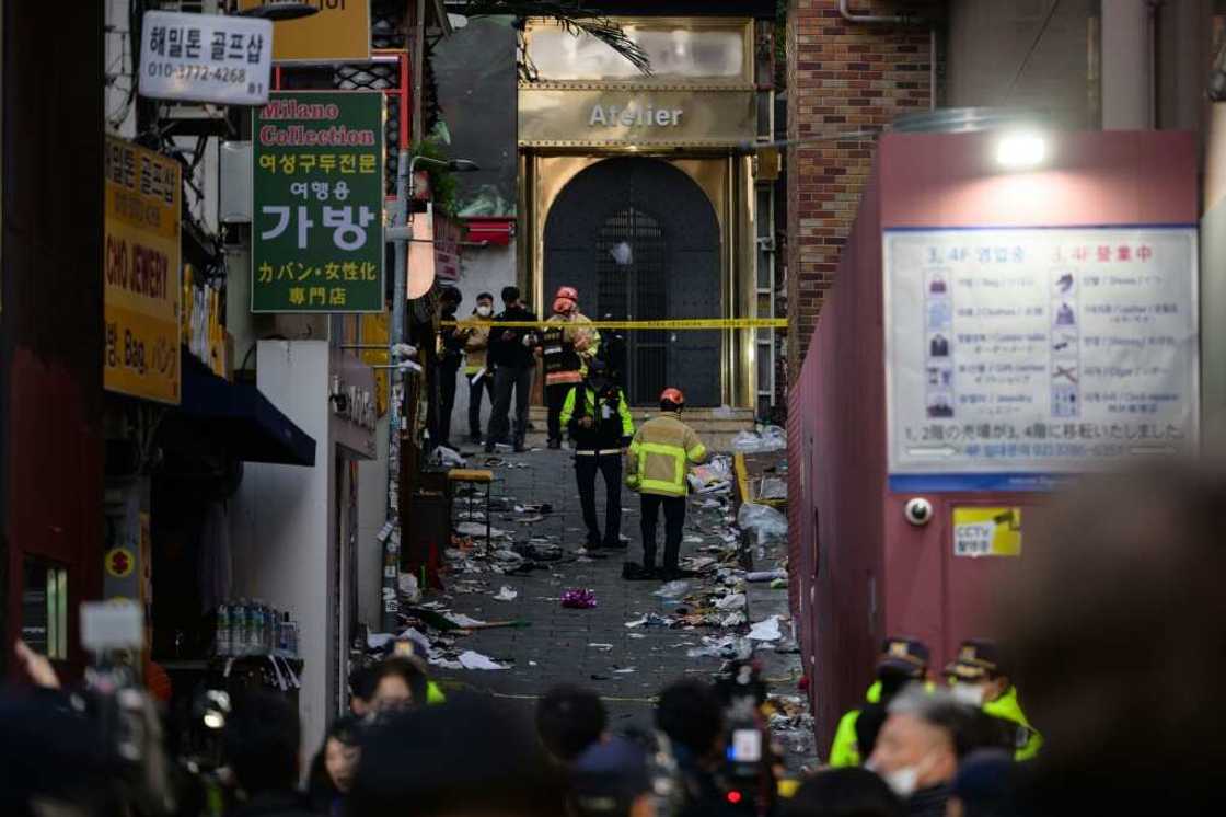 Emergency service personnel are seen in the narrow alley in Itaewon district where a stampede took place, killing more than 150 people Emergency service personnel are seen in the narrow alley in Itaewon district where a stampede took place, killing more than 150 people