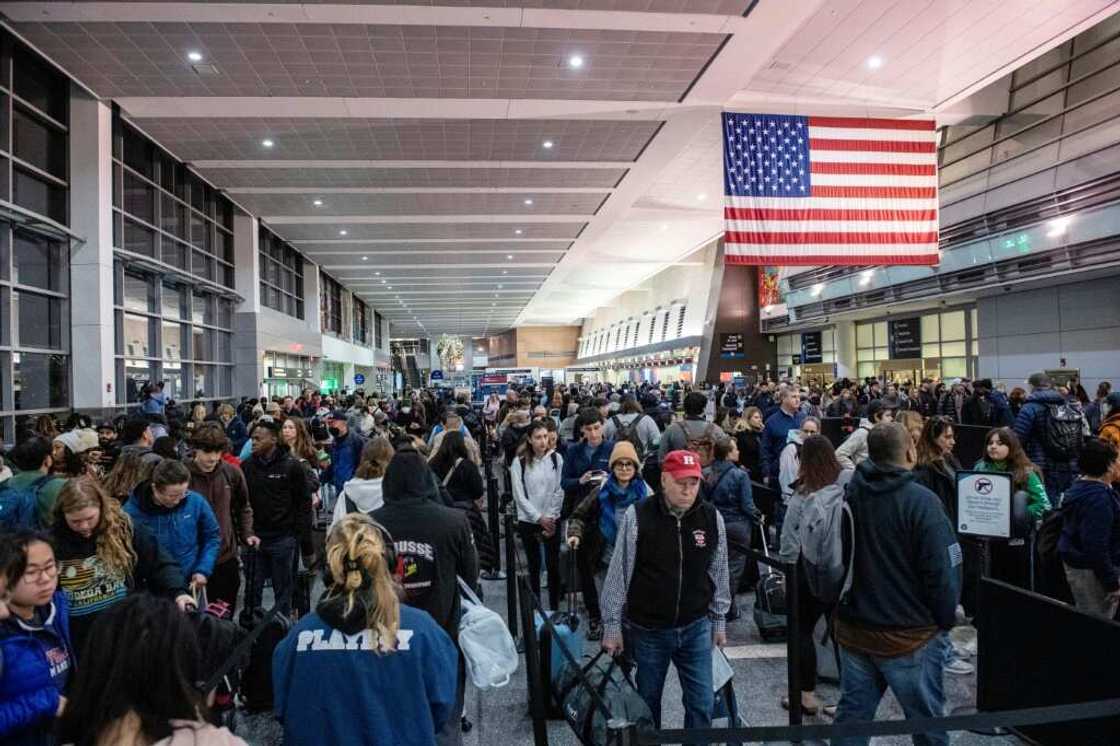 Travelers wait in the security line in Terminal A at Boston Logan International Airport in Boston, Massachusetts on December 21, 2023