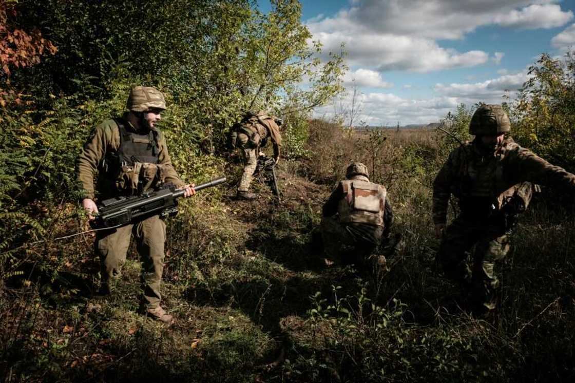 Ukrainian soldiers prepare an automatic grenade launcher on the front line near Toretsk in the Donetsk region on October 12, 2022 Ukrainian soldiers prepare an automatic grenade launcher on the front line near Toretsk in the Donetsk region on October 12, 2022