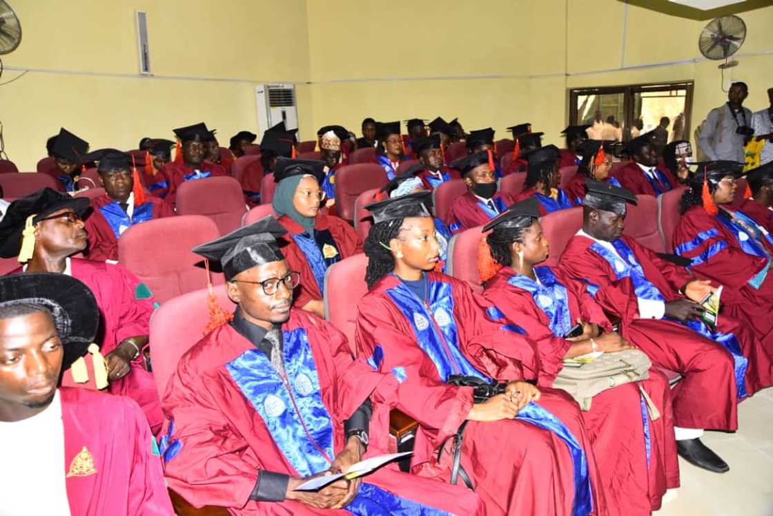 Ahmadu Bello University graduates in maroon academic dresses on their graduation day Ahmadu Bello University graduates in maroon academic dresses on their graduation day