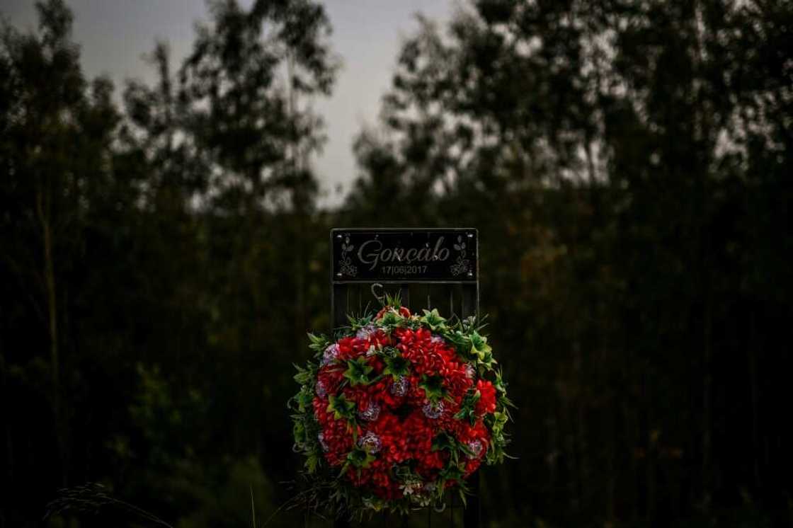 Flowers for the victims of the blaze by the side of a road in Pedrogao Grande