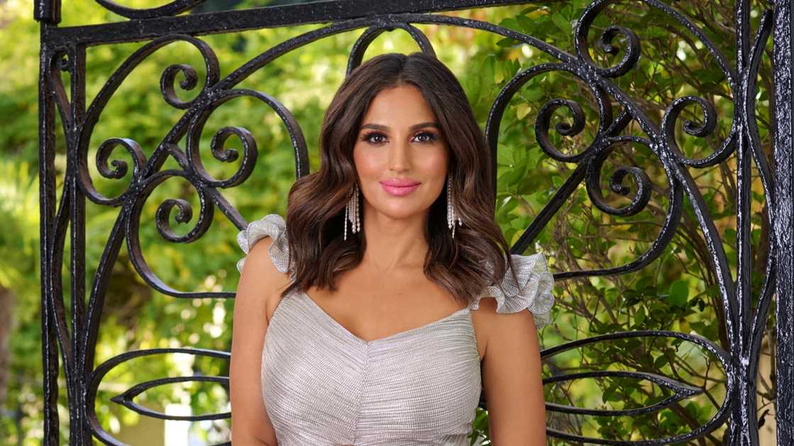 Leva Bonaparte poses standing for a Season 8 portrait in front of a black wrought iron gate. Leva Bonaparte poses standing for a Season 8 portrait in front of a black wrought iron gate.