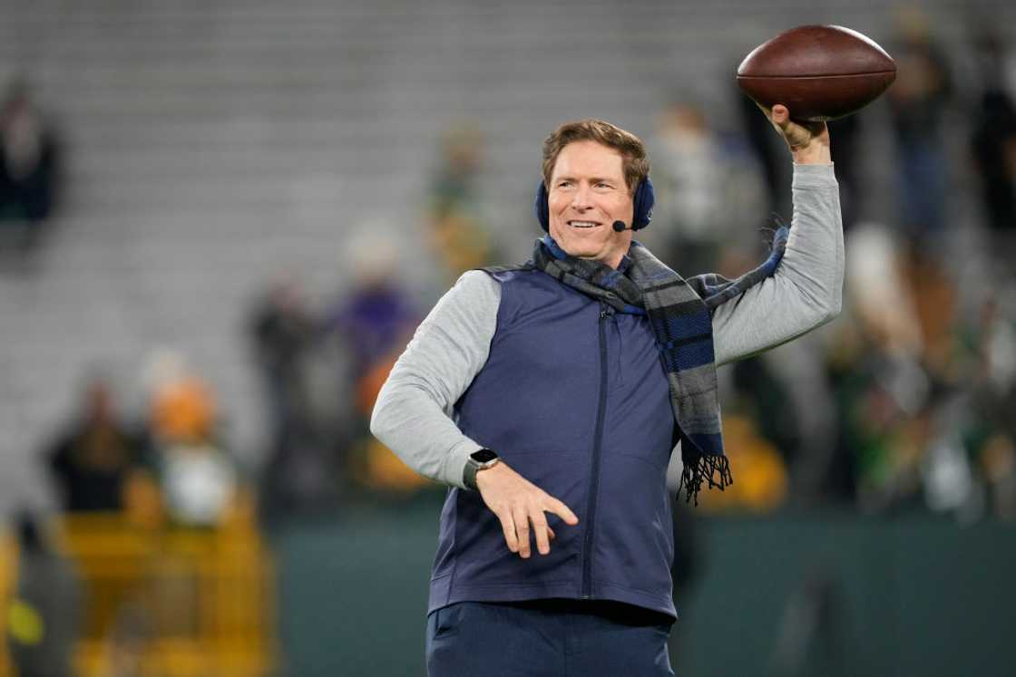 Steve Young throws a ball before an NFL game starts