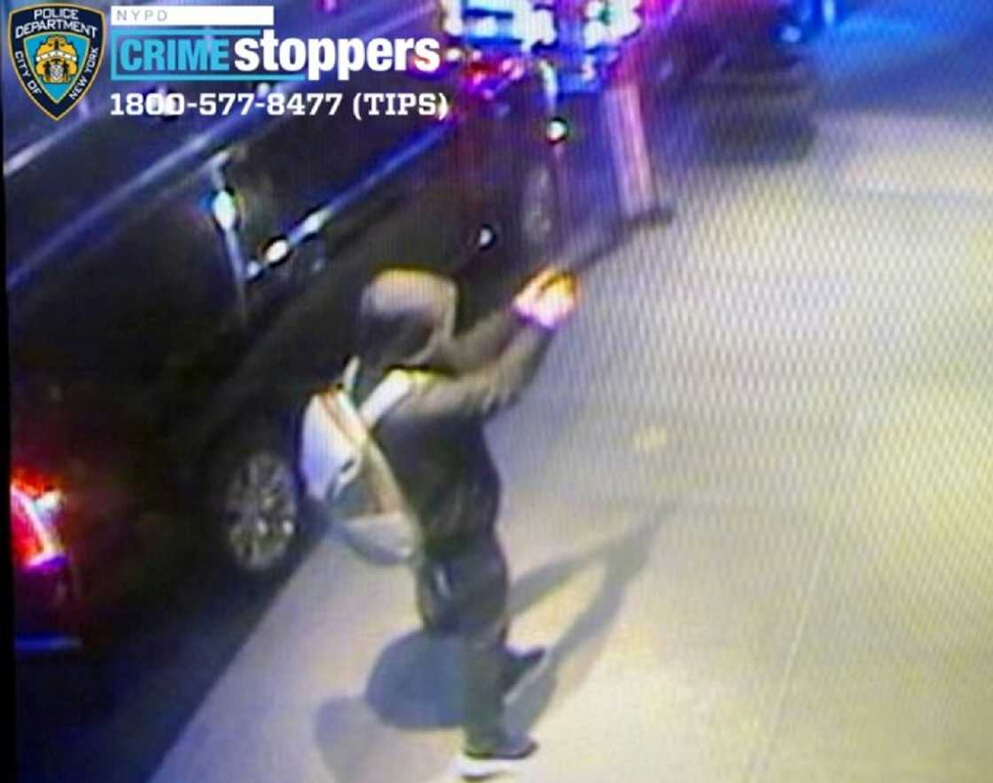 An unidentified hooded suspect draws a handgun, firing several shots at 50-year-old Thompson who crumples on the ground